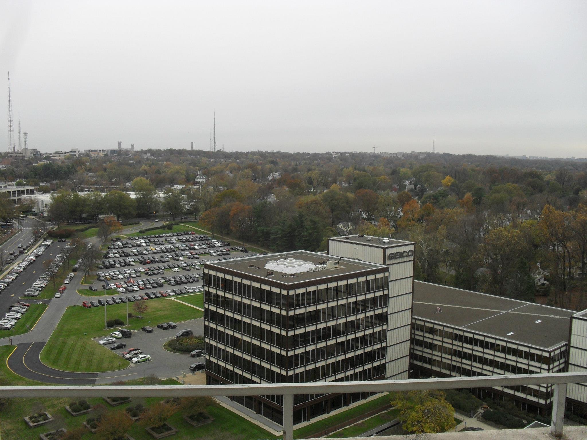 The 24th floor balcony of the pool storage room overlooks the GEICO building with a sweeping view of NW Washington and in the distance Virginia too 